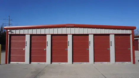 View of exterior storage units with red doors at Farmington, AR facility.
