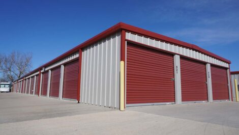 View of exterior storage units with red doors at Farmington, AR facility.