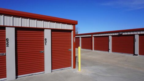 View of exterior storage units with red doors at Farmington, AR facility.