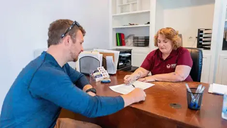 View of person signing contract at Fayetteville, AR Superior Storage facility.