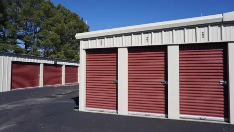 View of exterior storage units with red doors at Farmington, AR facility.